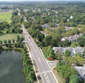 aerial-view-of-road-along-community-and-body-of-water
