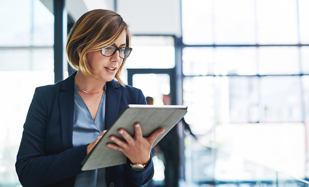 business-woman-reviewing-nots-on-tablet